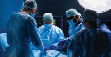 Surgeons performing complex procedure in an operating room, illustrating advanced surgical technology integration.