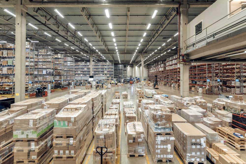 Wide view of PostNord TPL’s large-scale pharmaceutical distribution facility in Sweden, showing high racks and palletised goods.