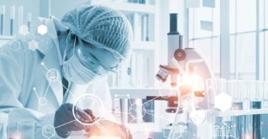 Scientist using AI-driven software for drug discovery in a biotechnology lab