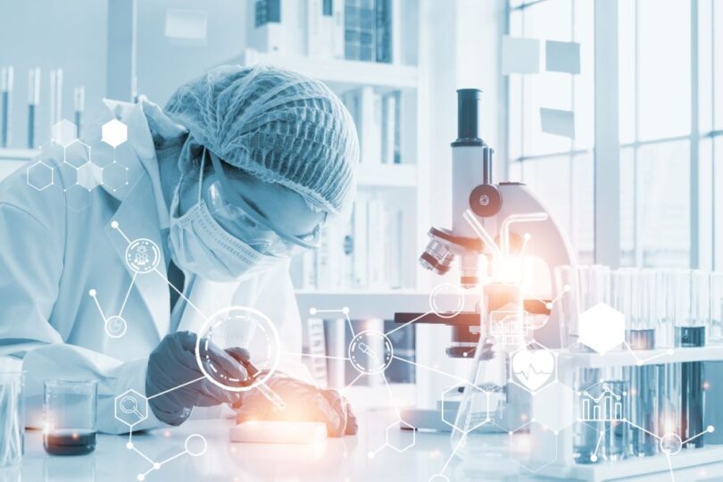 Scientist using AI-driven software for drug discovery in a biotechnology lab