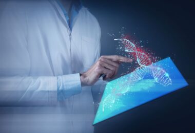 Scientists working with automated cell therapy manufacturing system