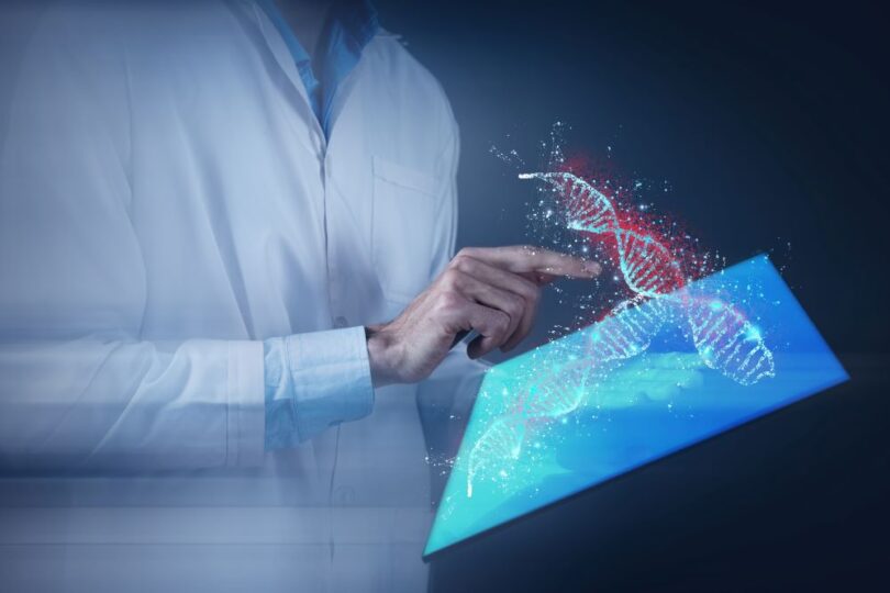 Scientists working with automated cell therapy manufacturing system