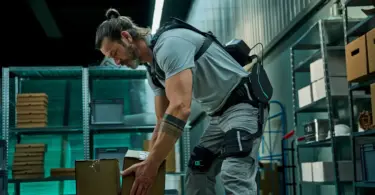Smart exoskeletons and digital ergonomics system supporting worker lifting boxes in industrial environment