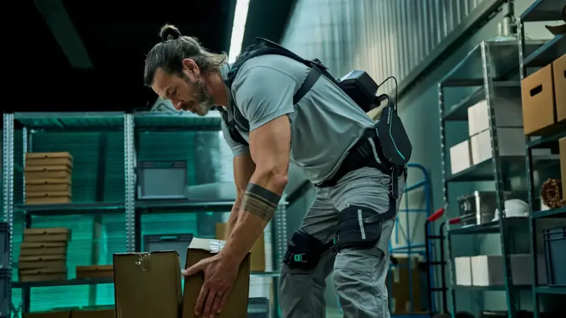 Smart exoskeletons and digital ergonomics system supporting worker lifting boxes in industrial environment