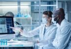 Life sciences professionals reviewing digital data within a modern biotechnology laboratory